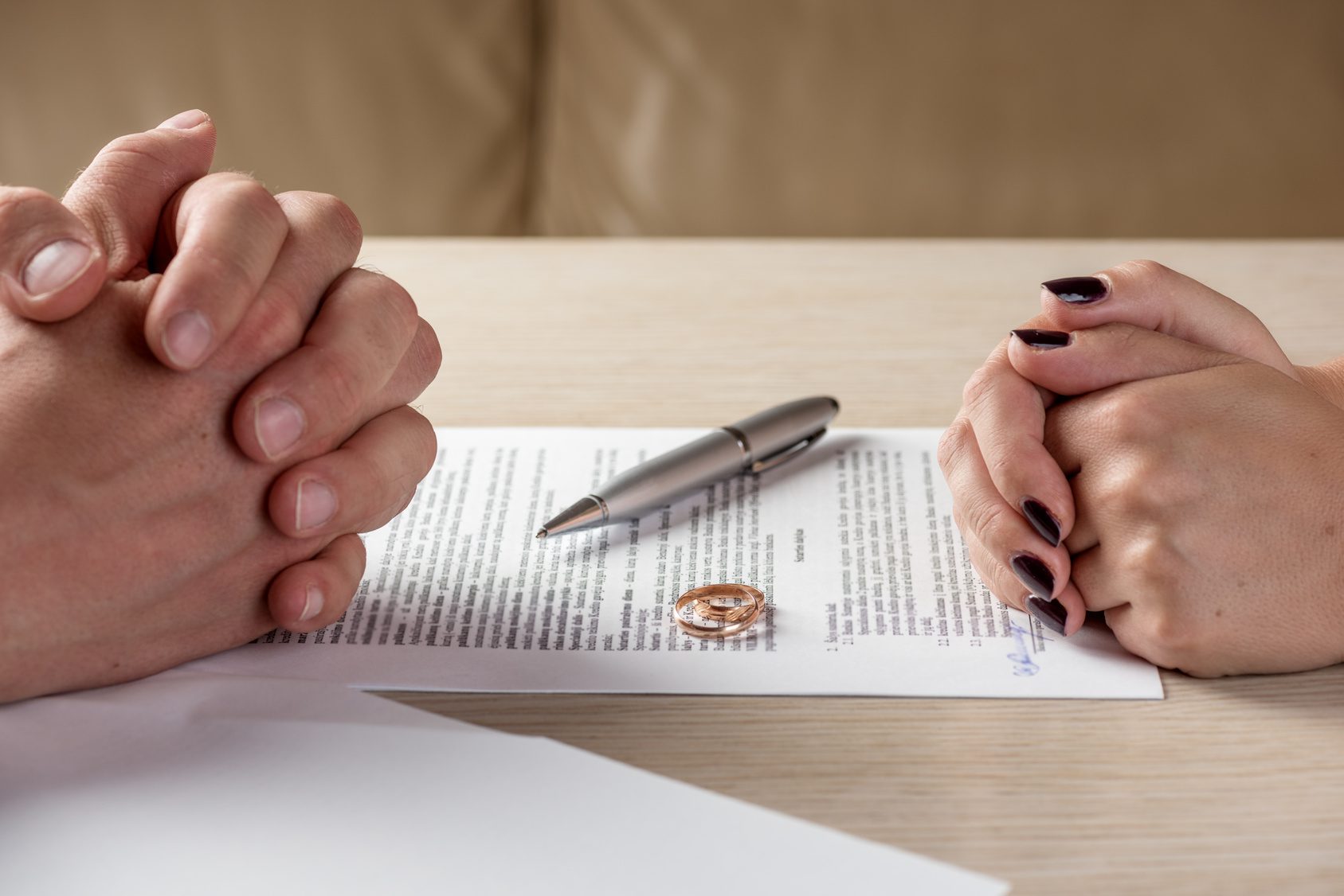 Wife and husband signing divorce documents with help from divorce lawyers dayton