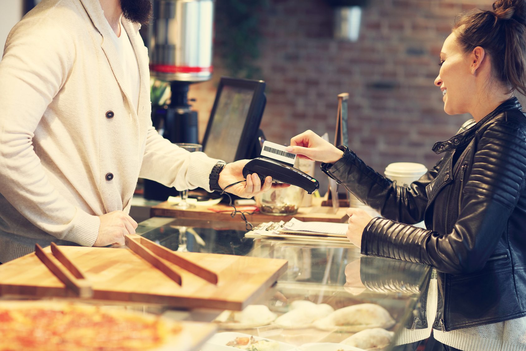 Picture of woman paying by credit card in restaurant owned by a person calling a divorce attorney dayton